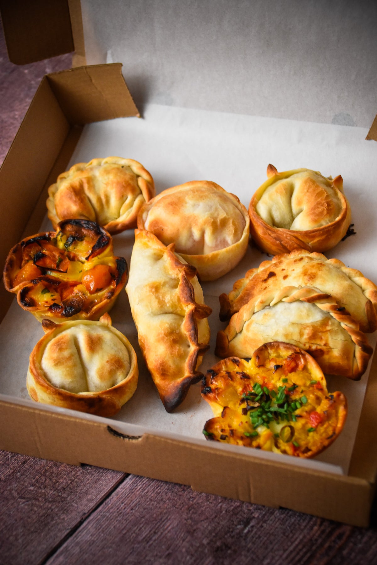 A box of golden-baked Aconcagua Kitchen empanadas ready to share